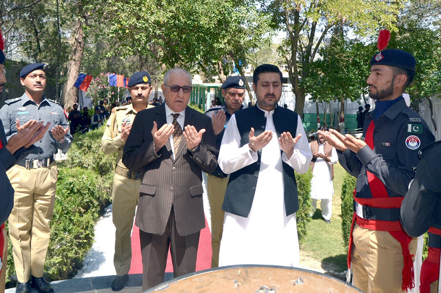 caretaker balochistan chief minister alauddin marri governor muhammad khan achakzai and lea personnel offer fateha for the martyrs of the police force in quetta photo express