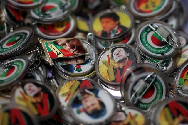pins with images of imran khan leader of the pakistan tehreek e insaf pti are pictured at a market a day after general election in islamabad photo reuters