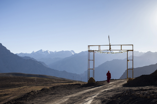 a buddhist monk stands outside a monastery in komik india photo afp