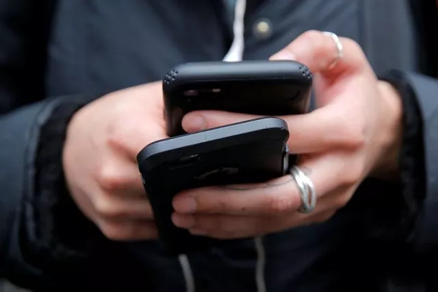 a woman uses her cell phones in manhattan new york us january 30 2018 photo reuters a woman uses her cell phones in manhattan new york us january 30 2018 photo reuters