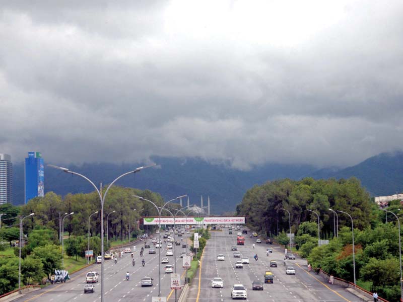 storm clouds over the capital where children play in rainwater in the downpour that flooded many areas of rawalpindi photo express agencies