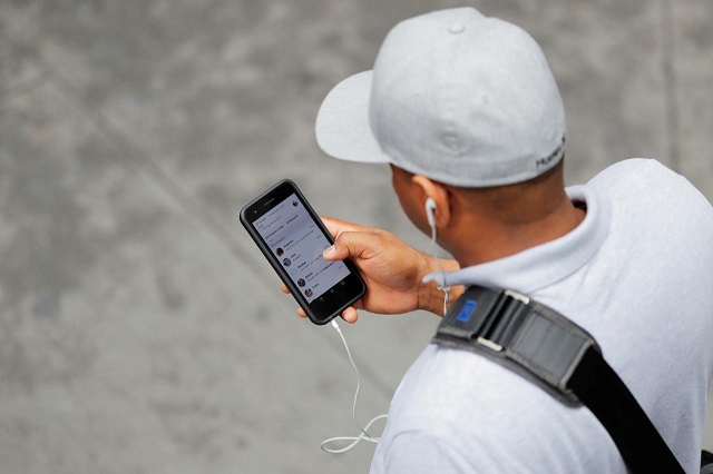 a man holds an apple iphone as he walks on a street in new york us august 1 2018 photo reuters