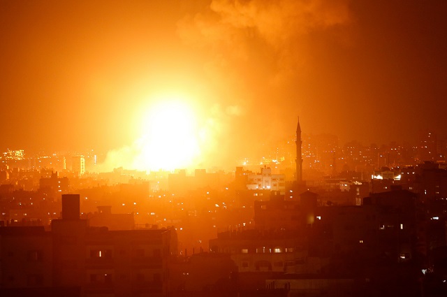 a fireball exploding during israeli air strikes in gaza city photo afp