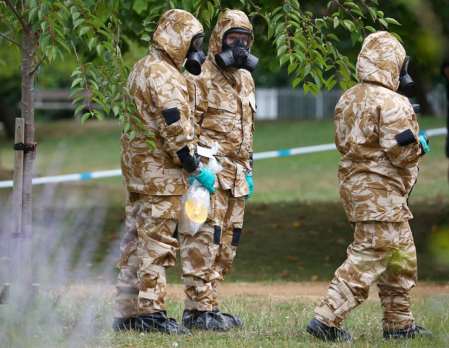 people in military hazardous material protective suits collect an item in queen elizabeth gardens in salisbury britain july 19 2018 photo reuters