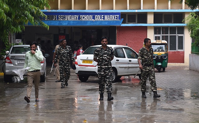 indian security forces walk inside the government school where a seven years old girl student was sexually assaulted in new delhi on august 10 2018 photo reuters