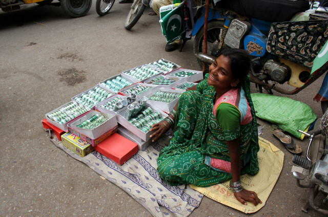 a hindu salesman asha selling white and green bangles for independence day at paper market photo athar khan a hindu salesman asha selling white and green bangles for independence day at paper market photo athar khan