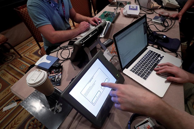 hackers try to access and alter data from an electronic poll books in a voting machine hacking village during the def con hacker convention in las vegas nevada us july 29 2017 photo reuters