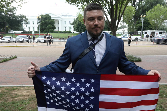 white nationalist leader jason kessler holds a flag across from the white house during a rally marking the one year anniversary of the 2017 charlottesville 039 unite the right 039 protests in washington d c august 12 2018 photo reuters