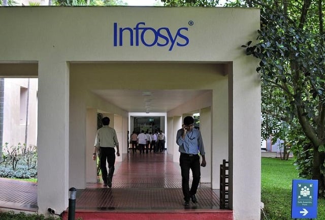 employees walk along a corridor in the infosys campus in the southern indian city of bangalore september 23 2014 photo reuters