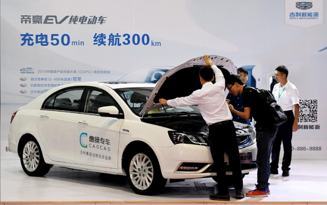 men look at an electric vehicle of caocao zhuanche a chauffeur ride hailing platform backed by zhejiang geely holding group at a new energy vehicle nev trade fair in zhengzhou henan province china september 23 2016 photo reuters