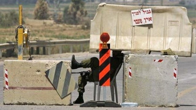 a soldier sits at a checkpoint during israel 039 s blockade of the gaza strip photo ap a soldier sits at a checkpoint during israel 039 s blockade of the gaza strip photo ap