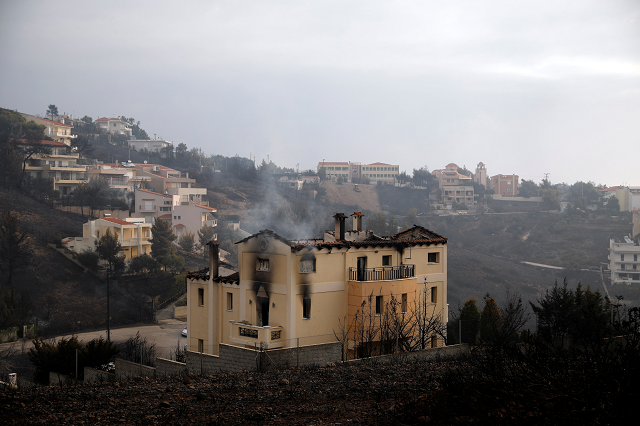 a house burns in the wake of a wildfire in neos voutzas near athens greece photo reuters a house burns in the wake of a wildfire in neos voutzas near athens greece photo reuters