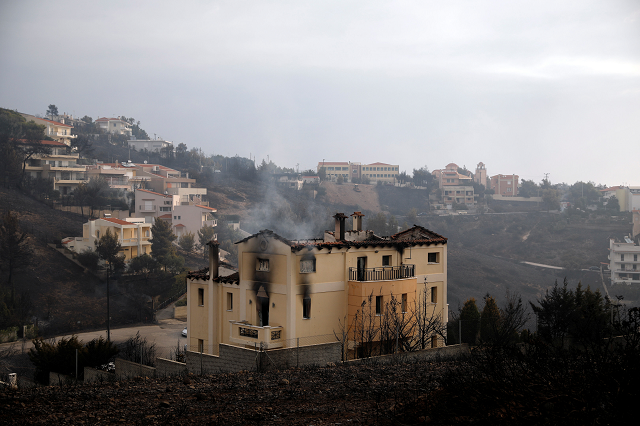 a house burns in the wake of a wildfire in neos voutzas near athens greece photo reuters