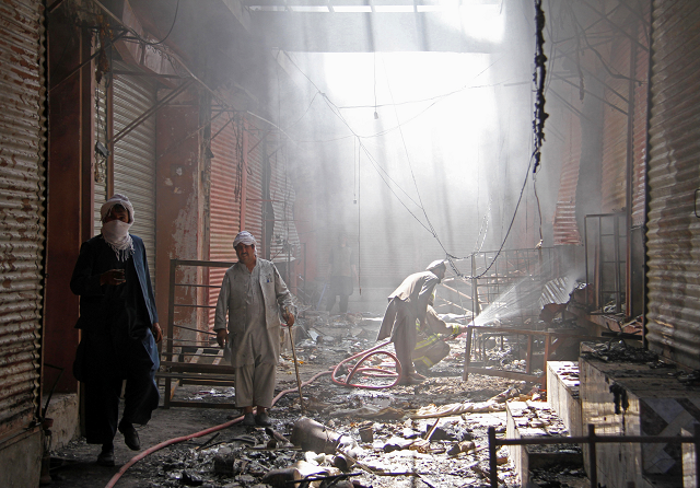 an afghan firefighter sprays water on buring shops after a taliban attack in ghazni city photo reuters an afghan firefighter sprays water on buring shops after a taliban attack in ghazni city photo reuters