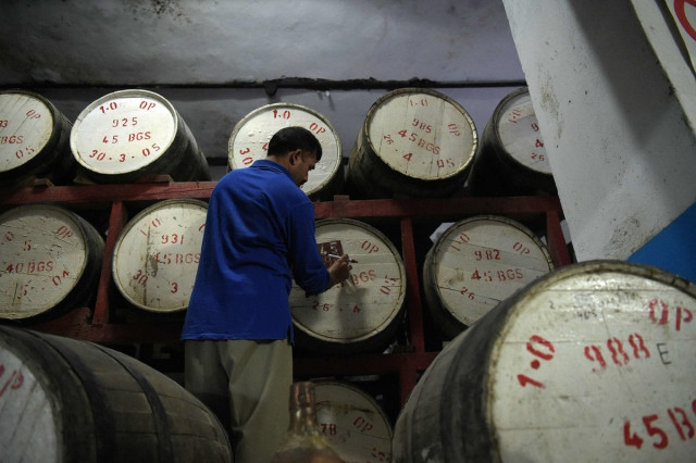 a worker labeling casks photo afp a worker labeling casks photo afp