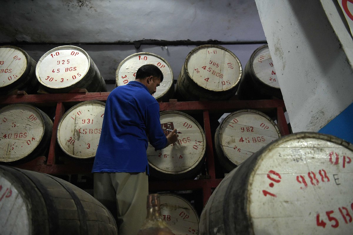 a worker labeling casks photo afp