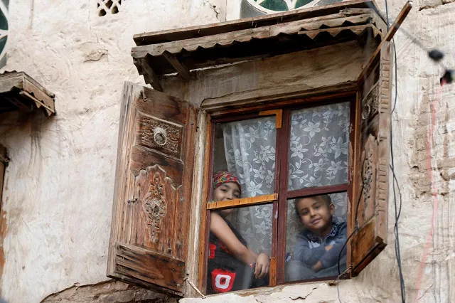 children look from behind a window of a house in the old quarter of sanaa yemen august 6 2018 photo reuters children look from behind a window of a house in the old quarter of sanaa yemen august 6 2018 photo reuters