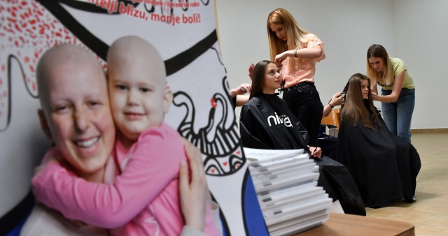 hairdressers prepare the hair of young donors before snipping off some as part of the 039 my hair your hair 039 campaign in sarajevo on may 25 2018 photo afp