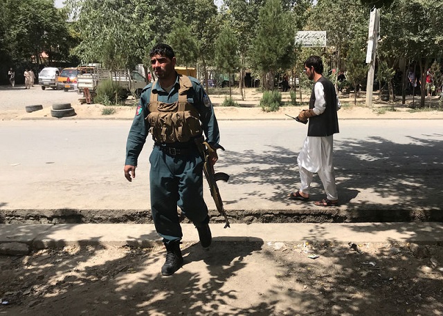 an afghan policeman keeps watch near the site of an attack in kabul afghanistan august 16 2018 photo reuters