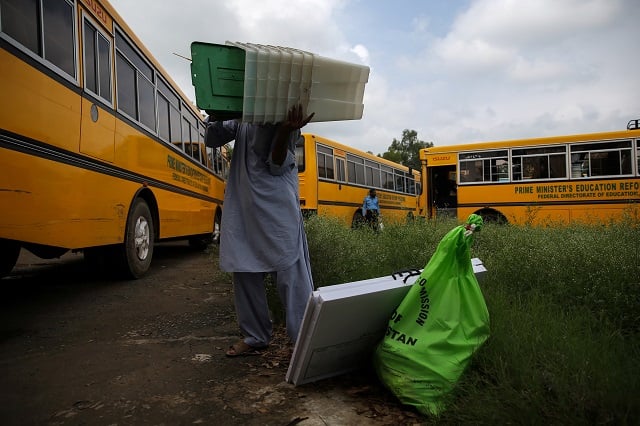 an election official carries election materials at a distribution centre ahead of general election in islamabad july 24 2018 photo reuters