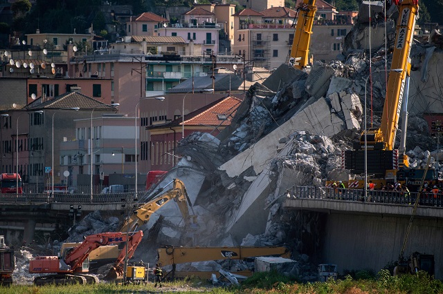 rescuers work among the rubble and wreckage of the morandi motorway bridge in genoa on august 17 2018 photo afp