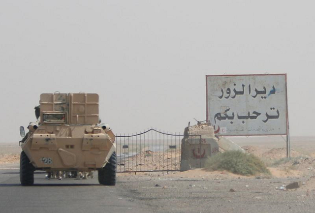 an armoured vehicle drives through oilfield photo reuters