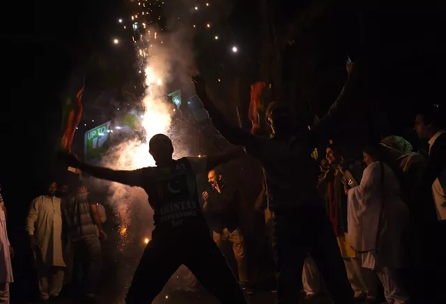 supporters of pakistan 039 s cricketer turned politician and head of the pakistan tehreek e insaf movement for justice imran khan celebrate after khan takes oath as a prime minister in lahore on august 18 2018 photo afp