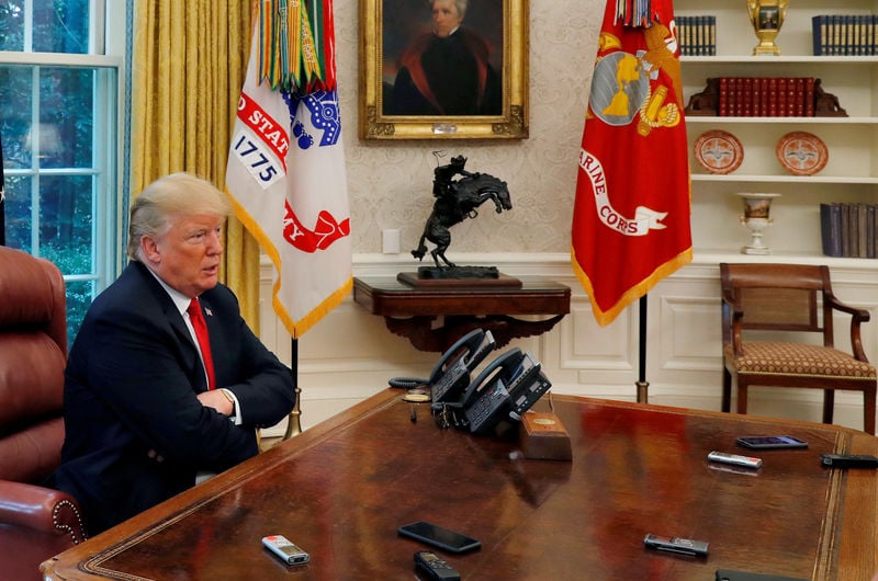 us president donald trump answers a reporter 039 s question as eight different phones and recording devices placed on his desk by reporters and white house staff members record his words during an interview with reuters in the oval office of the white house in washington us august 20 2018 photo reuters