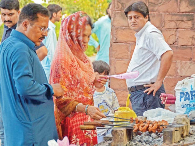 people enjoy a ride at lakeview park wahile a family cooks barbeque on the third day of eidul azha photo zafar aslam express people enjoy a ride at lakeview park wahile a family cooks barbeque on the third day of eidul azha photo zafar aslam express