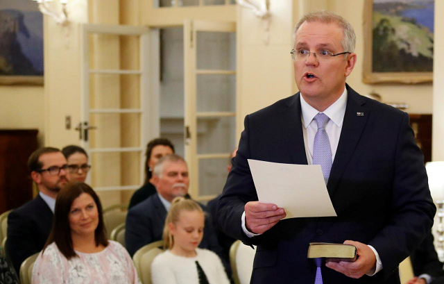 the new australian prime minister scott morrison attends a swearing in ceremony as his wife jenny looks on in canberra australia august 24 2018 photo reuters