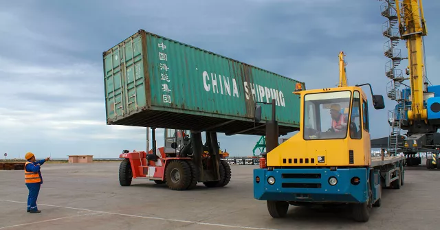 workers load a shipping crate in the kazakhstan 039 s caspian seaport of aktau on august 14 2018 with the outlines of its six idle cranes obscured by thick fog and pouring rain kazakhstan 039 s caspian seaport aktau seems an unlikely frontier on china 039 s much hyped new silk road but the sleepy port which has been badly hit in recent years by new oil routes is vying for a slice of the pie as competition for chinese trade warms up on the shores of the world 039 s largest inland sea photo afp workers load a shipping crate in the kazakhstan 039 s caspian seaport of aktau on august 14 2018 with the outlines of its six idle cranes obscured by thick fog and pouring rain kazakhstan 039 s caspian seaport aktau seems an unlikely frontier on china 039 s much hyped new silk road but the sleepy port which has been badly hit in recent years by new oil routes is vying for a slice of the pie as competition for chinese trade warms up on the shores of the world 039 s largest inland sea photo afp