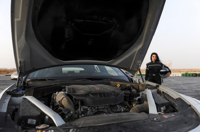 rana almimoni a 30 year old saudi motor racing enthusiast poses with her helmet next to her car on the track in dirab motor park photo afp rana almimoni a 30 year old saudi motor racing enthusiast poses with her helmet next to her car on the track in dirab motor park photo afp