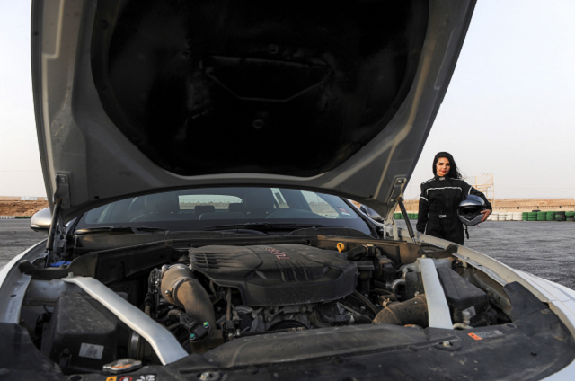 rana almimoni a 30 year old saudi motor racing enthusiast poses with her helmet next to her car on the track in dirab motor park photo afp