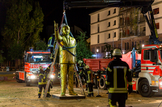 fireworkers lift a four metre tall golden statue featuring turkish president recep tayyip erdogan photo afp