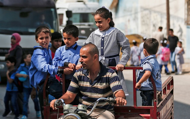 pupils are driven to a school run by the united nations agency for palestinian refugees unrwa in gaza city on august 29 2018 on the first day of classes after the summer holidays photo afp