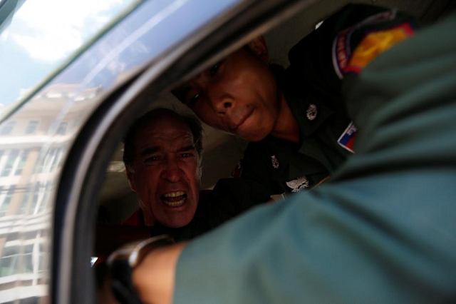 australian filmmaker james ricketson shouts inside a prison truck as he leaves the municipal court of phnom penh cambodia august 31 2018 photo reuters