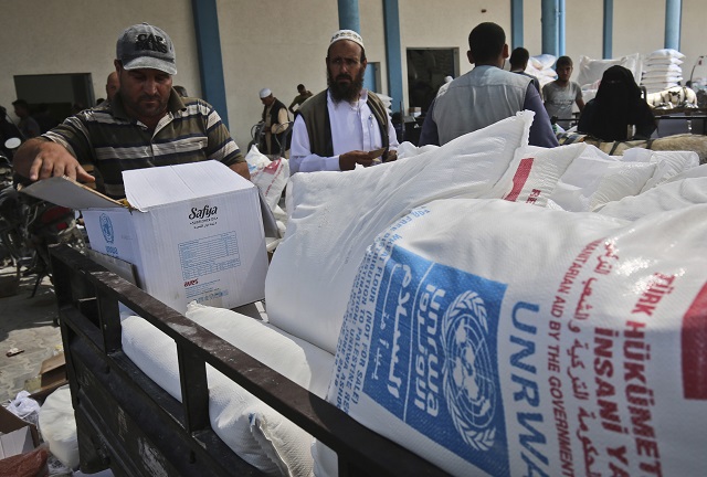 palestinian men collect aid food at a united nations 039 compound in the rafah refugee camp in the southern gaza strip on september 1 2018 photo afp