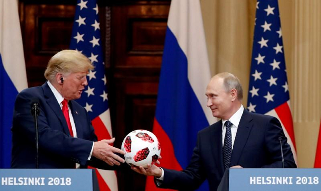 us president donald trump receives a football from russian president vladimir putin as they hold a joint news conference after their meeting in helsinki finland july 16 2018 photo reuters us president donald trump receives a football from russian president vladimir putin as they hold a joint news conference after their meeting in helsinki finland july 16 2018 photo reuters