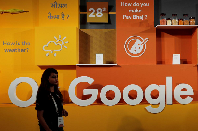 a woman walks past the logo of google during an event in new delhi india august 28 2018 photo reuters