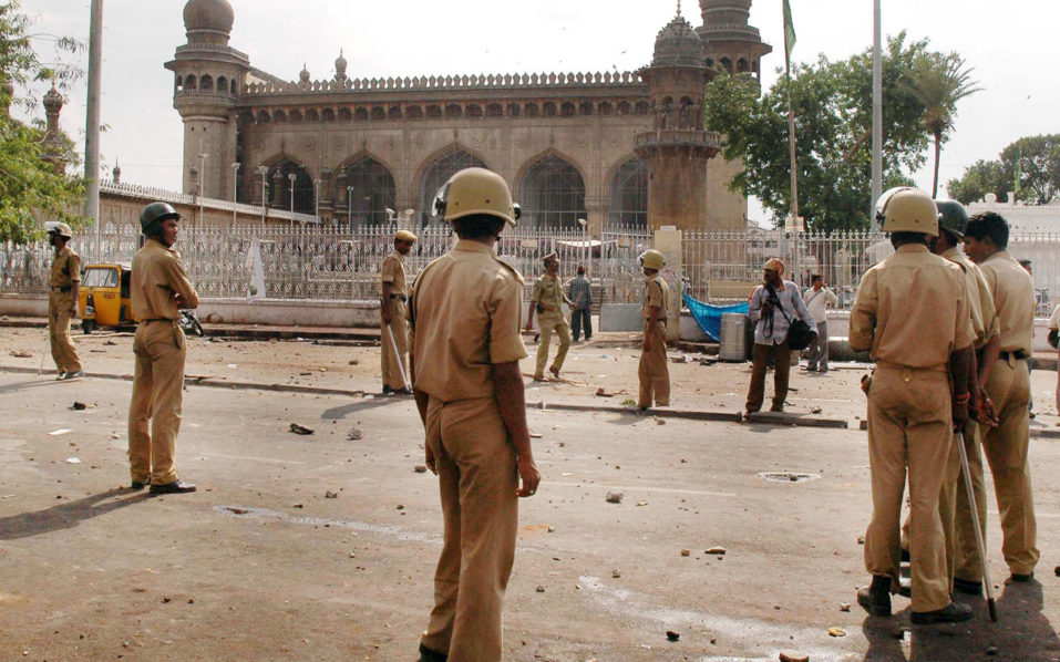 in this file photo taken on may 18 2007 police stand outside the macca masjid mosque in hyderabad following a deadly blast the may bombing came three months ahead of the twin august 25 2007 attacks in hyderabad that was blamed on the islamic indian mujahideen group an indian court on september 4 2018 convicted two members of the banned islamist militant group over the august blasts that killed 44 people photo afp