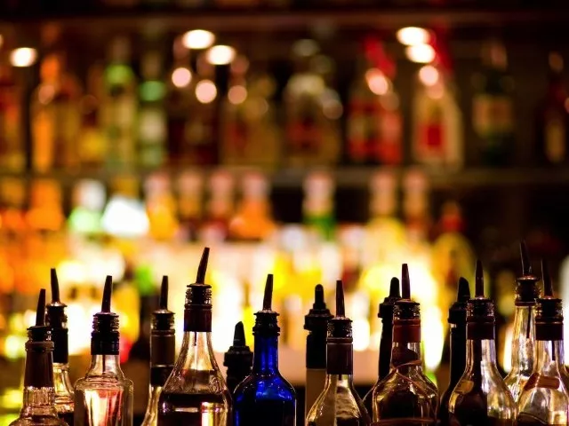 drug peddler held liquor bottles confiscated photo afp drug peddler held liquor bottles confiscated photo afp