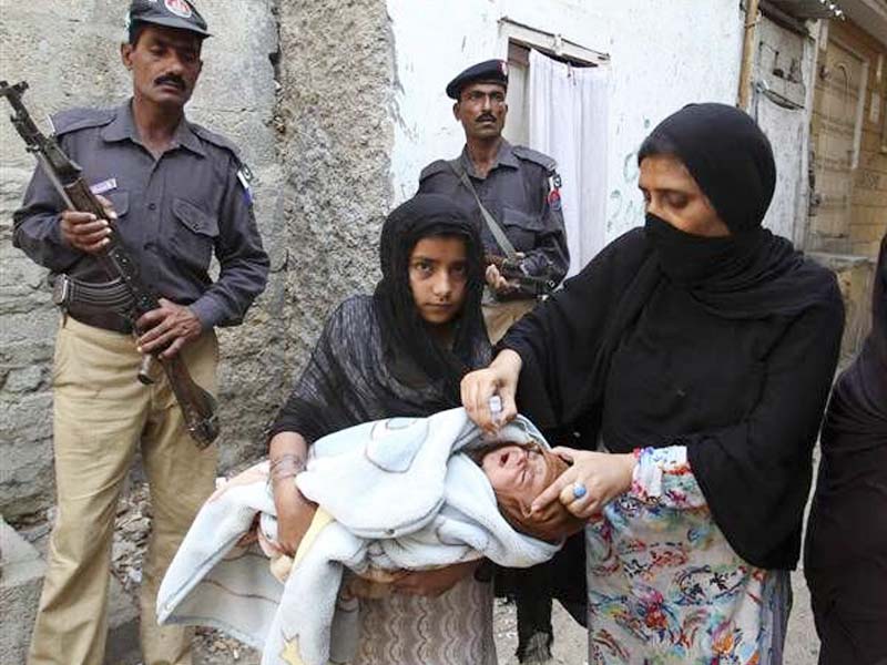 a health worker administers polio vaccination photo file