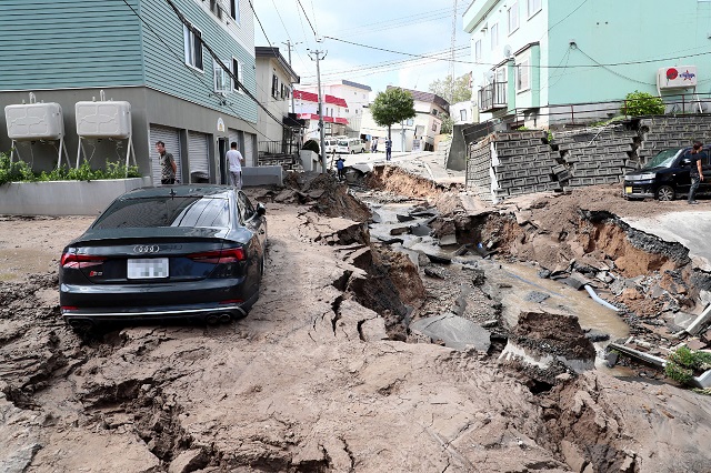 a car is seen stuck on a road damaged by an earthquake in sapporo hokkaido photo afp