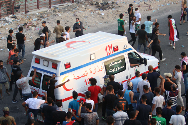 an iraqi ambulance leaves during a protest against the government photo afp an iraqi ambulance leaves during a protest against the government photo afp