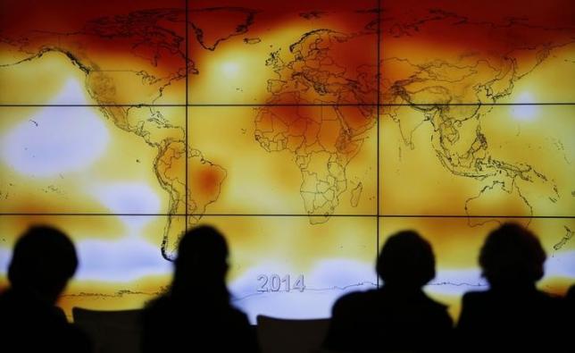 participants looks at a screen projecting a world map with climate anomalies photo reuters