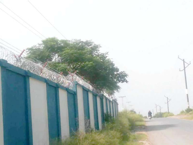 power lines pass over the boundary wall of a school in bani gala photo express power lines pass over the boundary wall of a school in bani gala photo express
