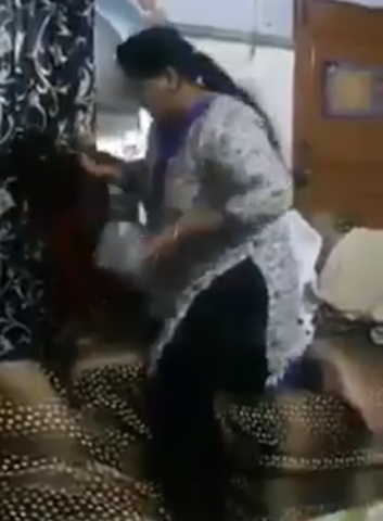 the video shows the woman slapping the young girl grabbing her by the ear screengrab