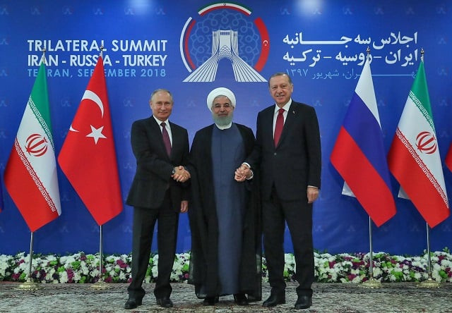 a handout picture provided by the office of iranian president hassan rouhani centre shows him holding hands with turkish president recep tayyip erodgan right and russian president vladimir putin in tehran on september 7 2018 photo afp a handout picture provided by the office of iranian president hassan rouhani centre shows him holding hands with turkish president recep tayyip erodgan right and russian president vladimir putin in tehran on september 7 2018 photo afp