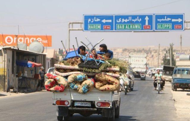 a syrian family rides with their belongings in a pick up truck as they head to safer areas in the northern part of rebel held idlib province on september 6 2018 to flee an expected regime assault photo afp