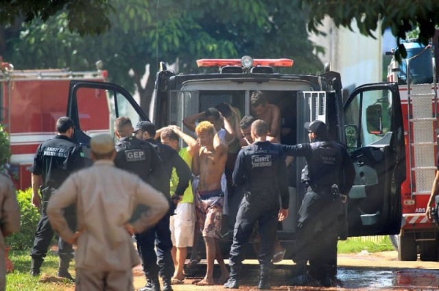 guards escort inmates back to the quot coronel odenir guimaraes quot state prison goias brazil in january this year brazil has the third largest prison population in the world photo afp